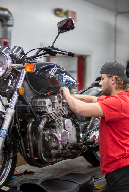 Honda motorcycle being serviced by a technician at Hamburg Honda’s service department