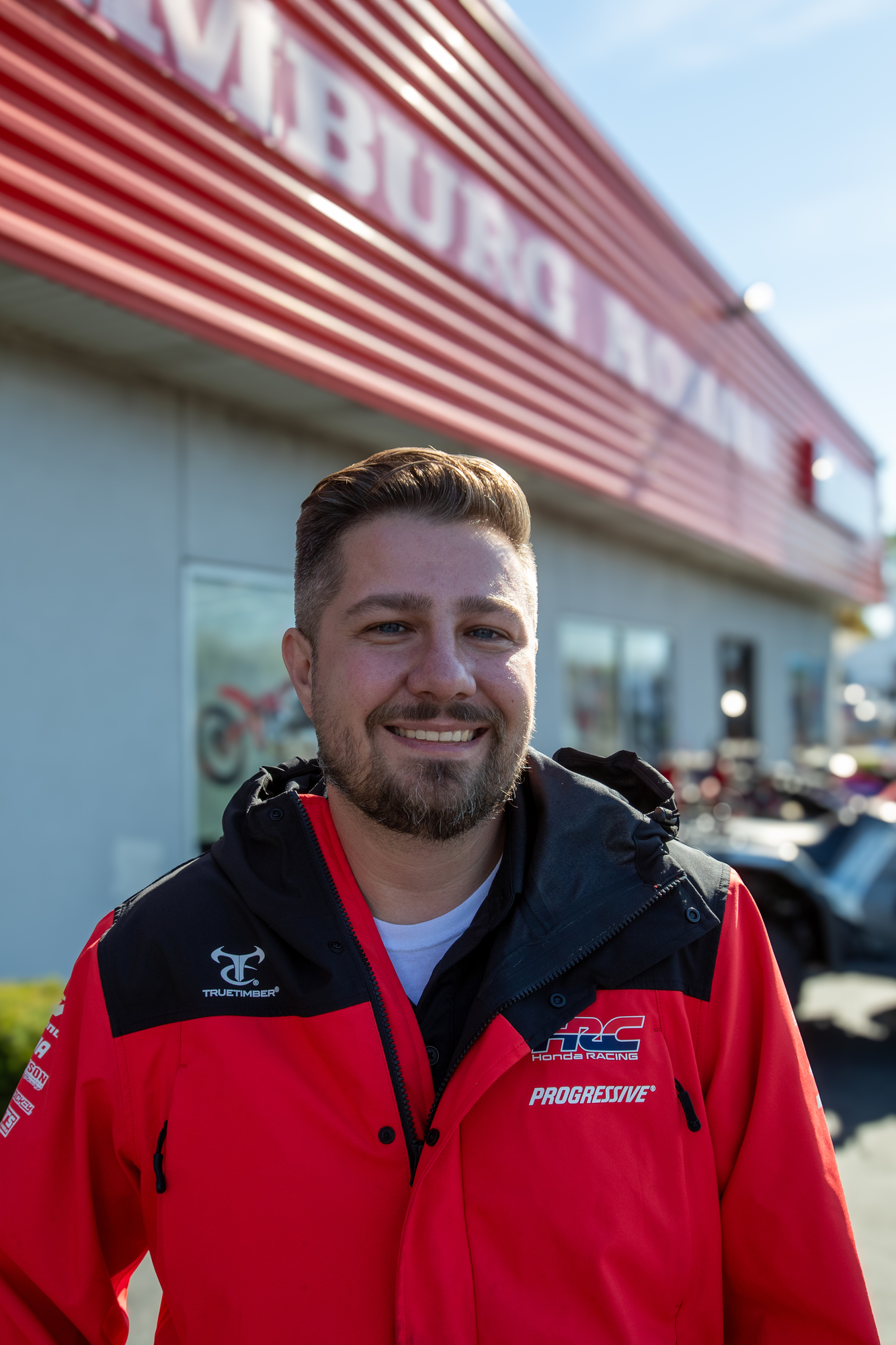 Strategic leader Dan standing outside Hamburg Honda in Honda Racing apparel.