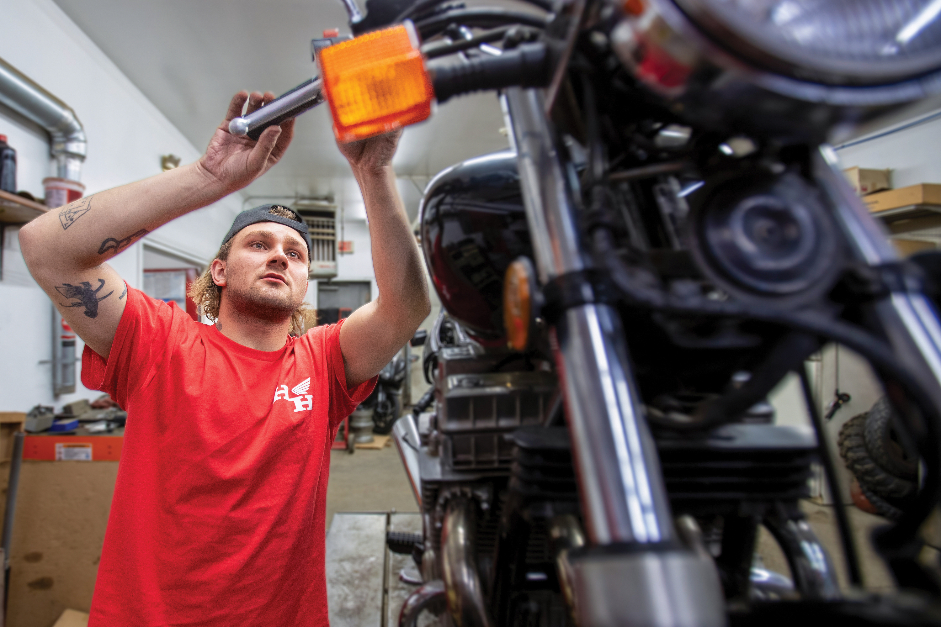 Hamburg Honda technician working on a motorcycle inside the service department.